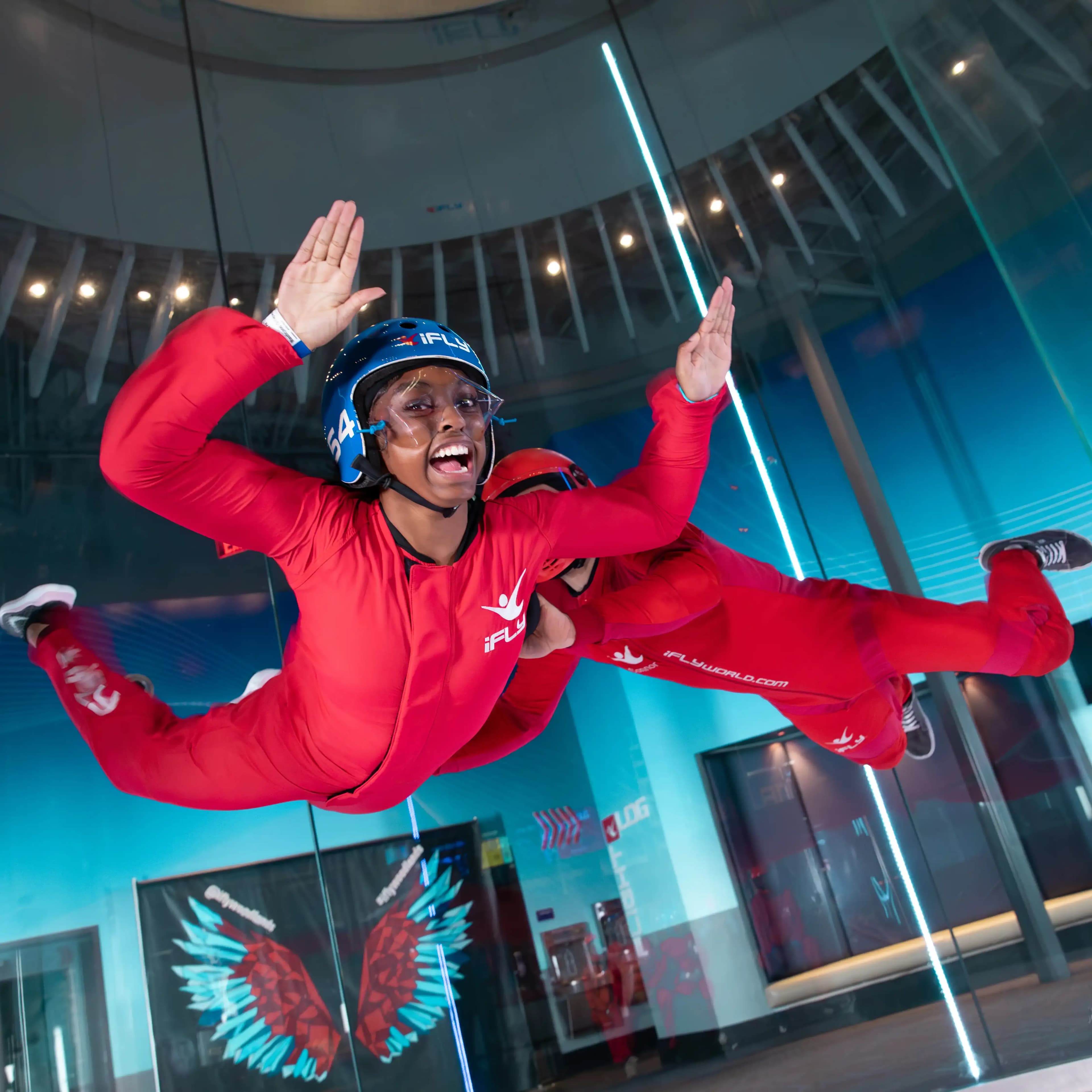 A young excited flyer gets assisted by an instructor during their flight