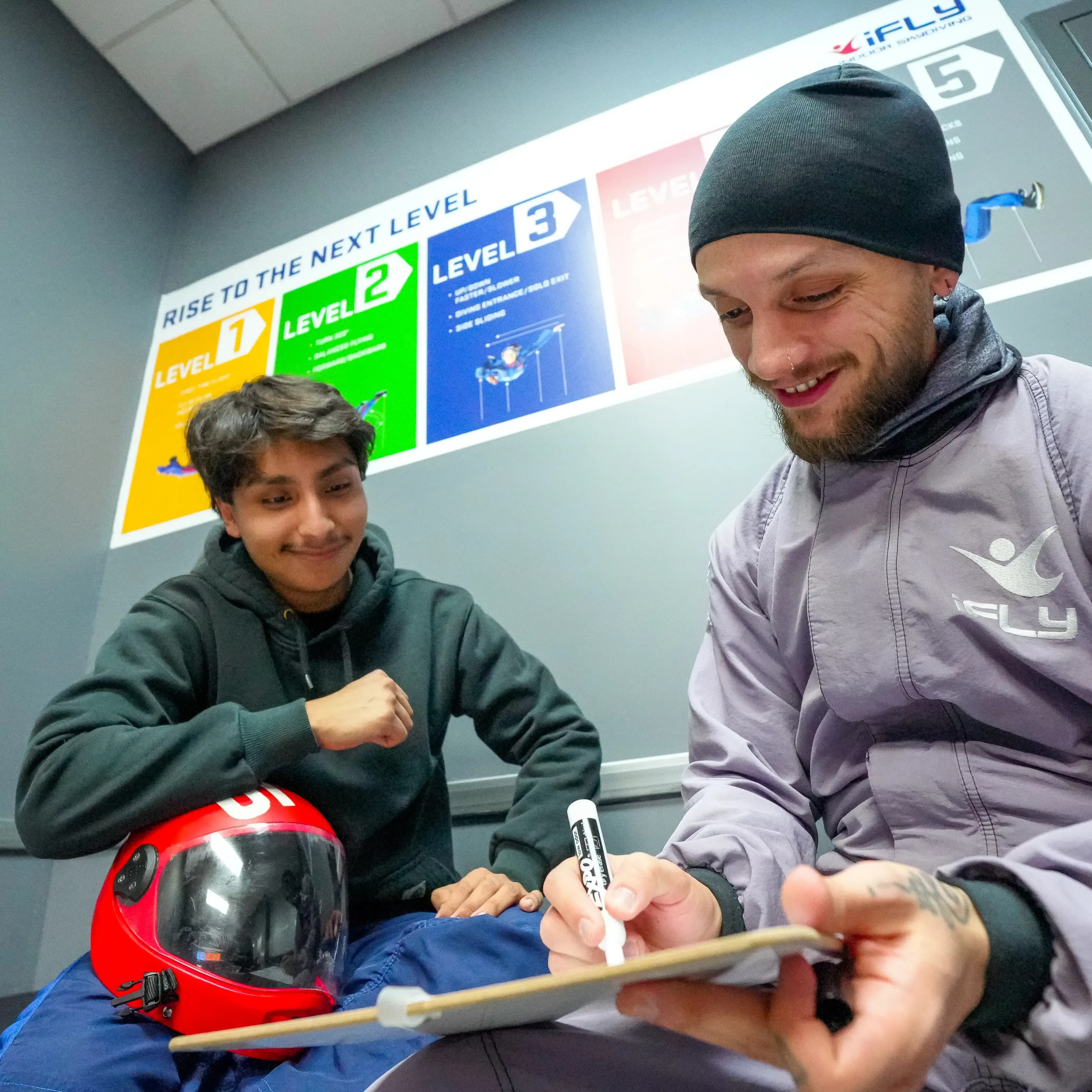 An instructor assists a flyer and teaches them