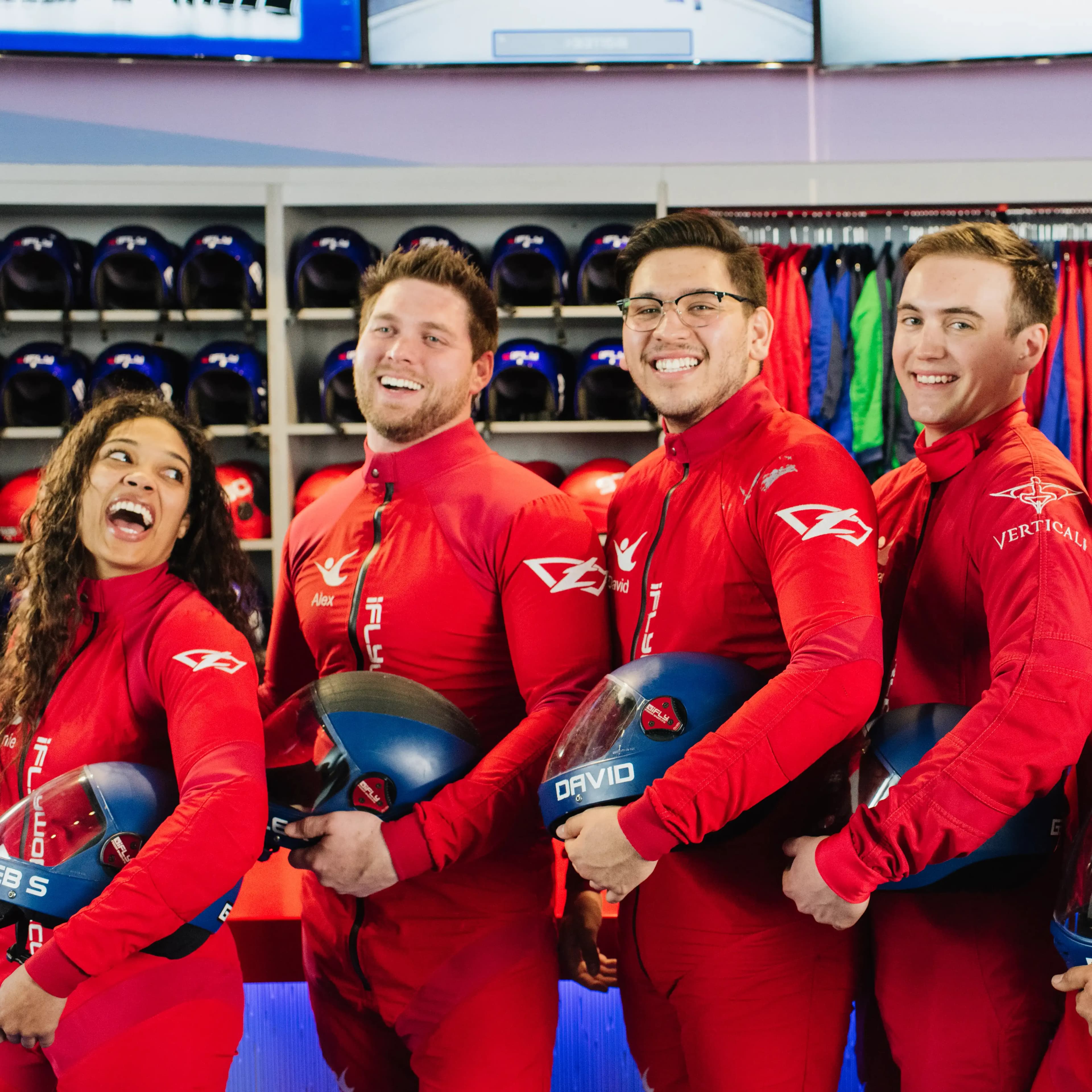 A group of 4 instructors all laughing and smiling with each other