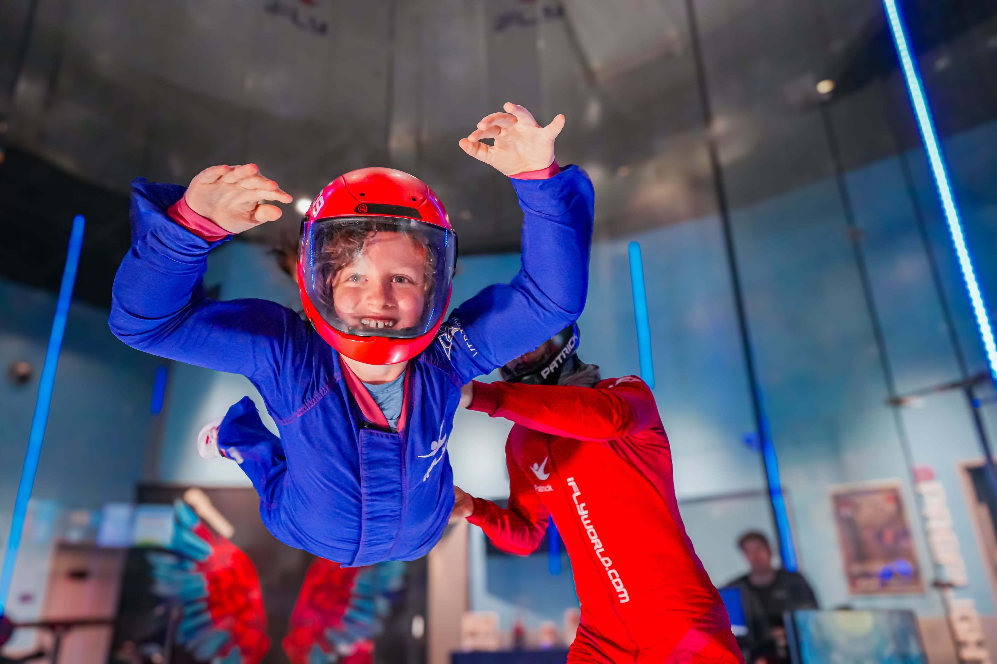 student flying inside wind tunnel
