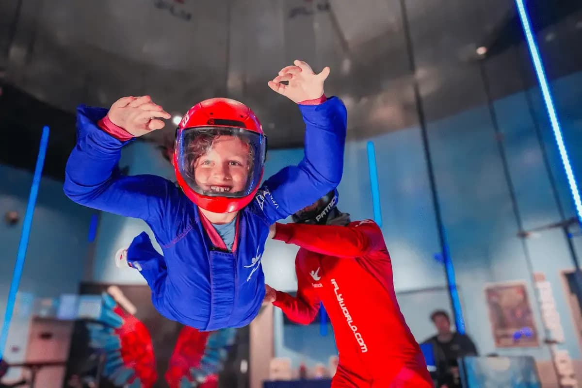 student flying in wind tunnel