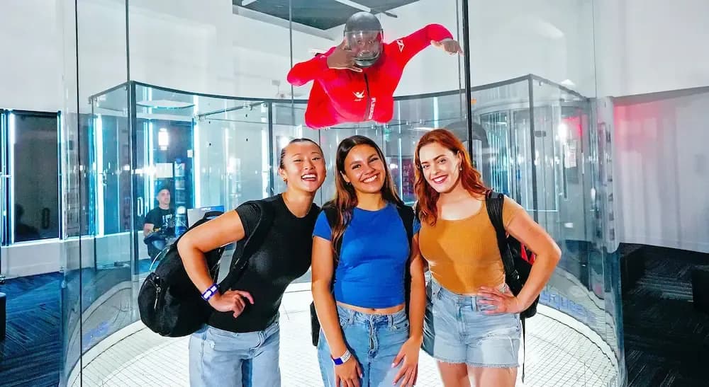 Three friends smiling in front of tunnel